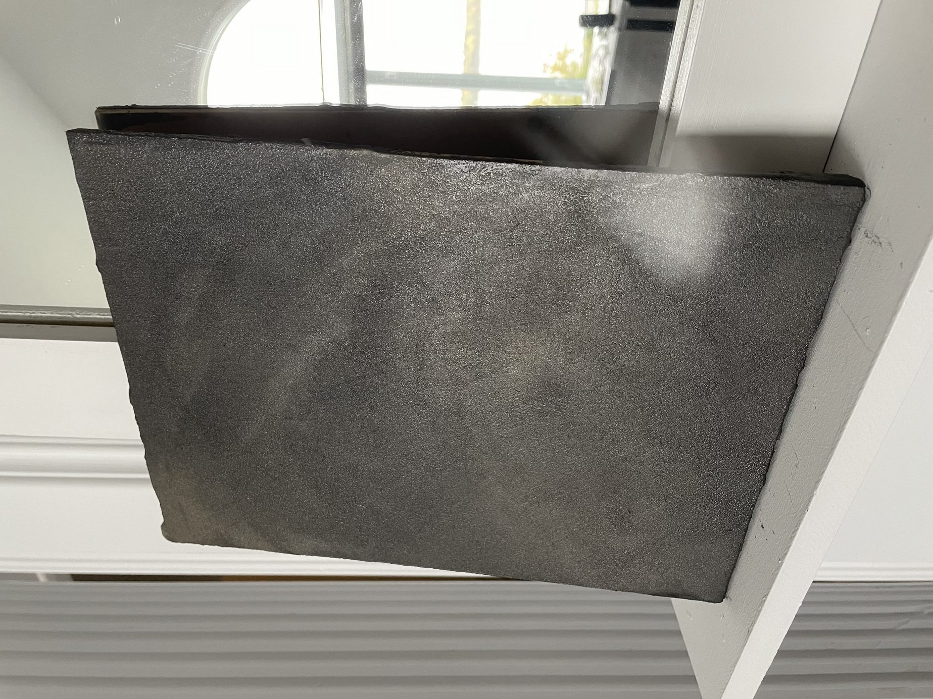 Venetian plaster accent wall with layered, polished finish showing depth and light reflection in modern condo interior