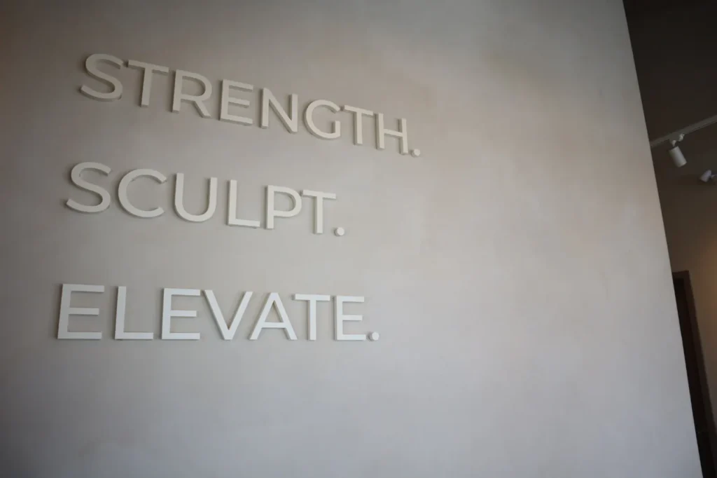 Dimensional lettering on a two-tone sandy limewash feature wall